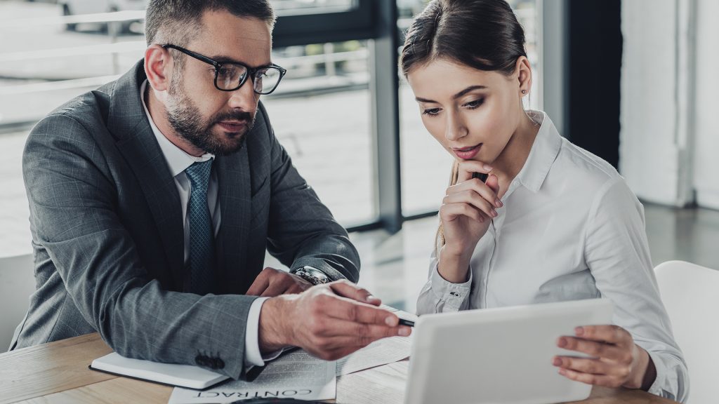 Prospect watching video testimonial during sales meeting